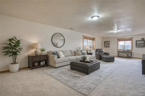 a living room with furniture and a potted plant