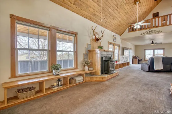 a view of a livingroom with furniture a ceiling fan and window
