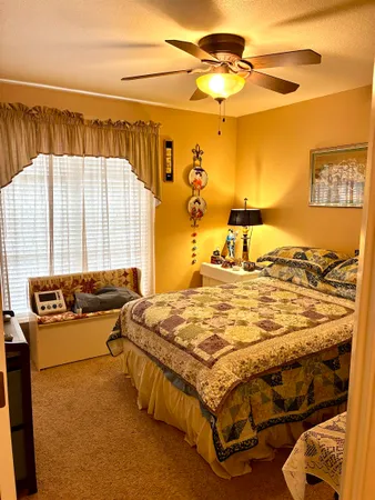 a bedroom with a bed and a view of living room