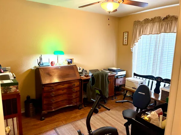 a view of workspace with wooden floor windows