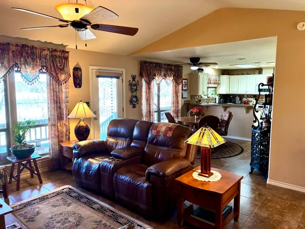 a living room with furniture a chandelier and a window