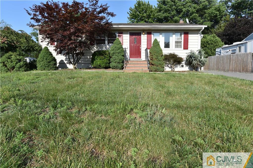 214 3rd Street Middlesex, NJ 08846 - Photo 2 of 22 a front view of a house with garden