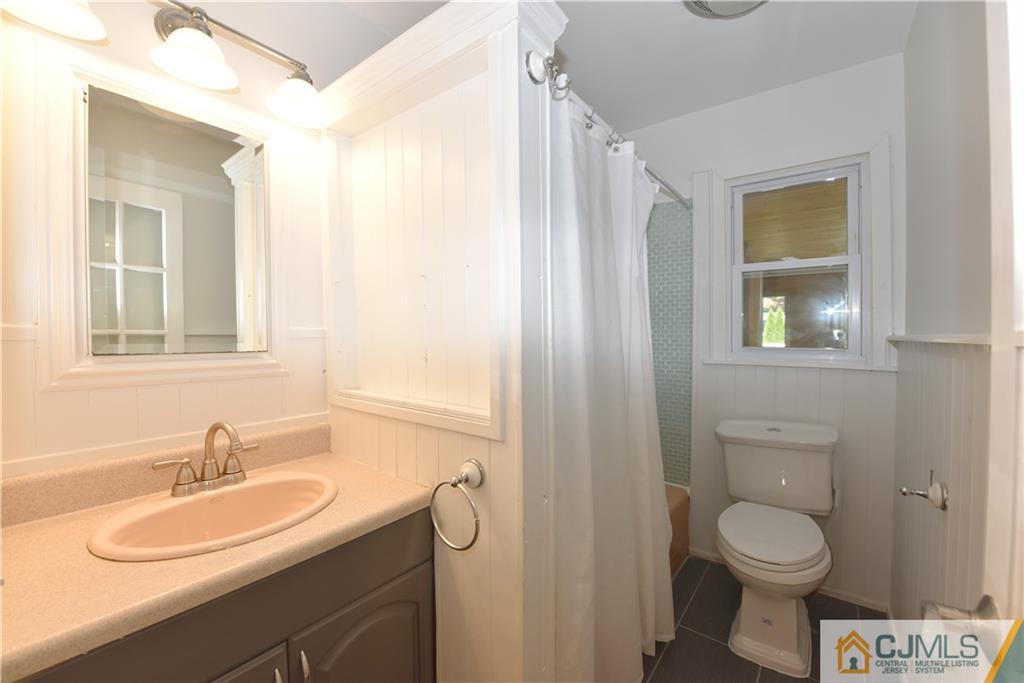 214 3rd Street Middlesex, NJ 08846 - Photo 11 of 22 a bathroom with a granite countertop sink toilet and shower