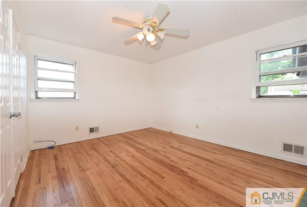 214 3rd Street Middlesex, NJ 08846 - Photo 12 of 22 wooden floor in an empty room with a window