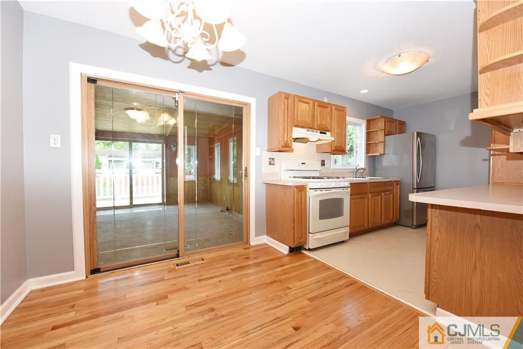 214 3rd Street Middlesex, NJ 08846 - Photo 5 of 22 a kitchen with stainless steel appliances granite countertop a refrigerator a sink dishwasher a stove with wooden cabinets and floor