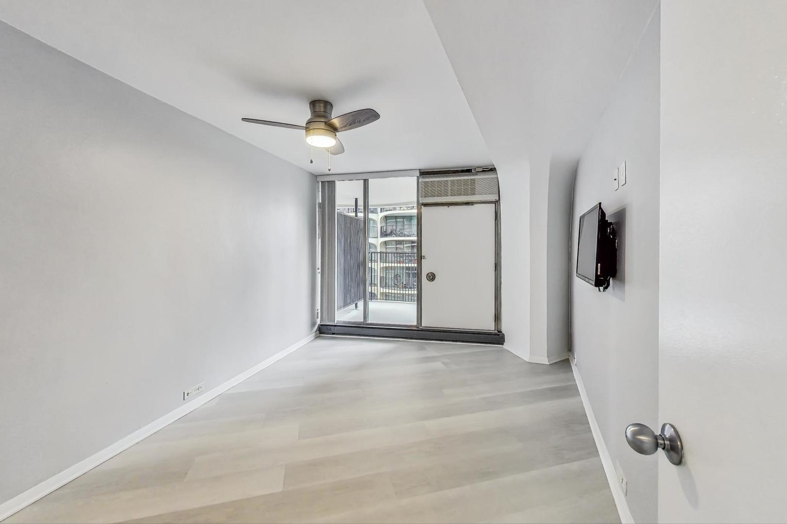 300 North State Street, Unit 4308 Chicago, IL 60654 - Photo 11 of 32 an empty room with windows and closet