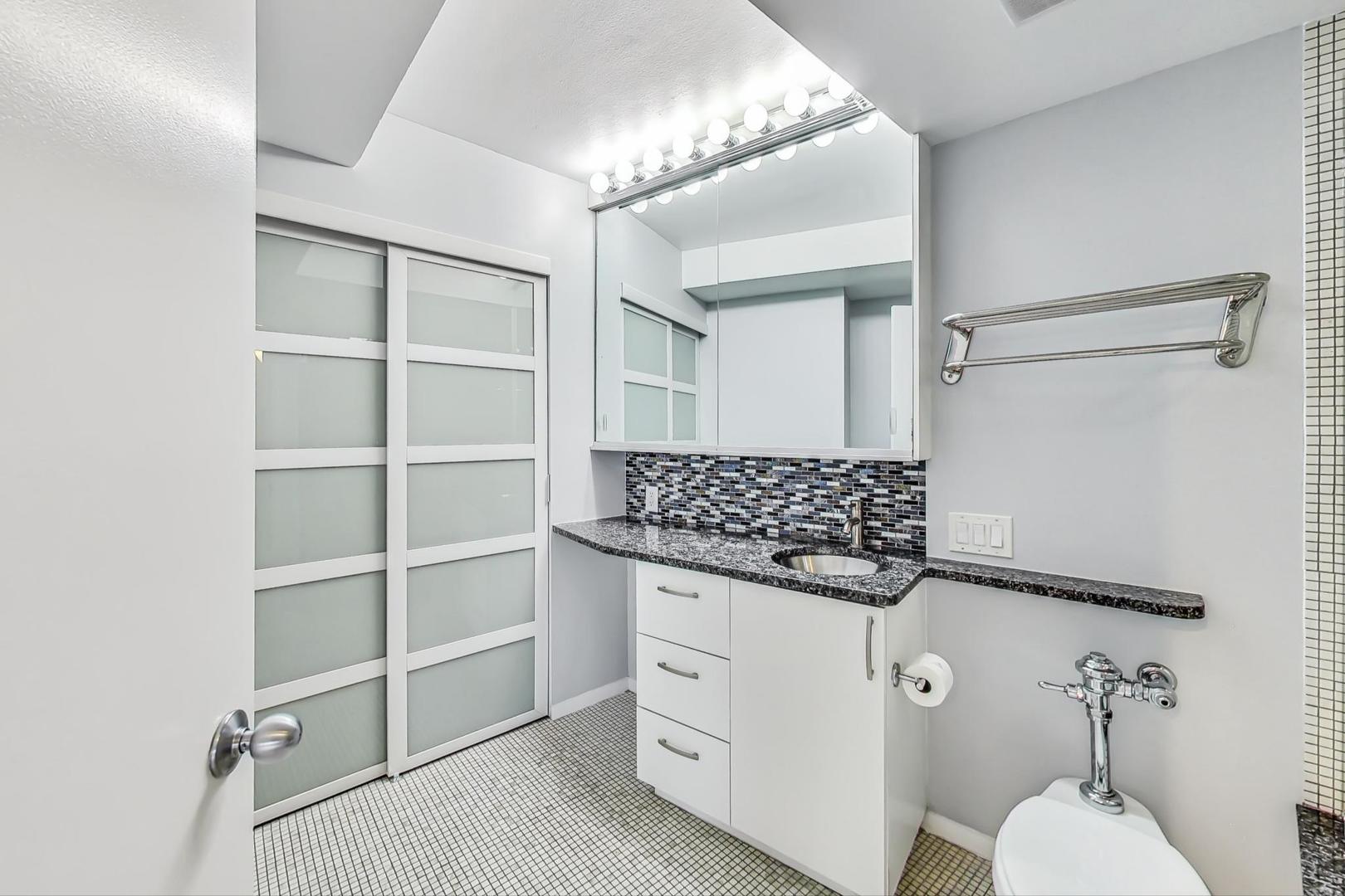 300 North State Street, Unit 4308 Chicago, IL 60654 - Photo 18 of 32 a kitchen with white cabinets and window