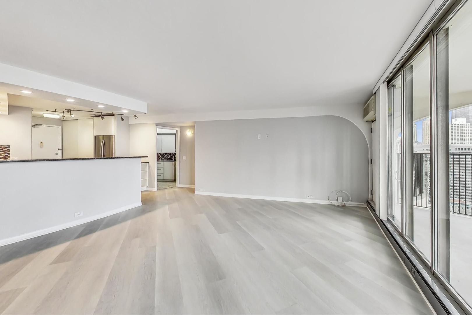 300 North State Street, Unit 4308 Chicago, IL 60654 - Photo 6 of 32 a view of a big room with wooden floor and windows