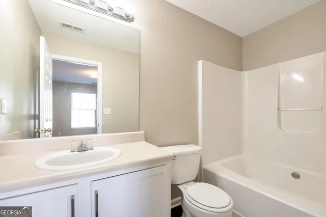 a bathroom with a sink a toilet and a bathtub