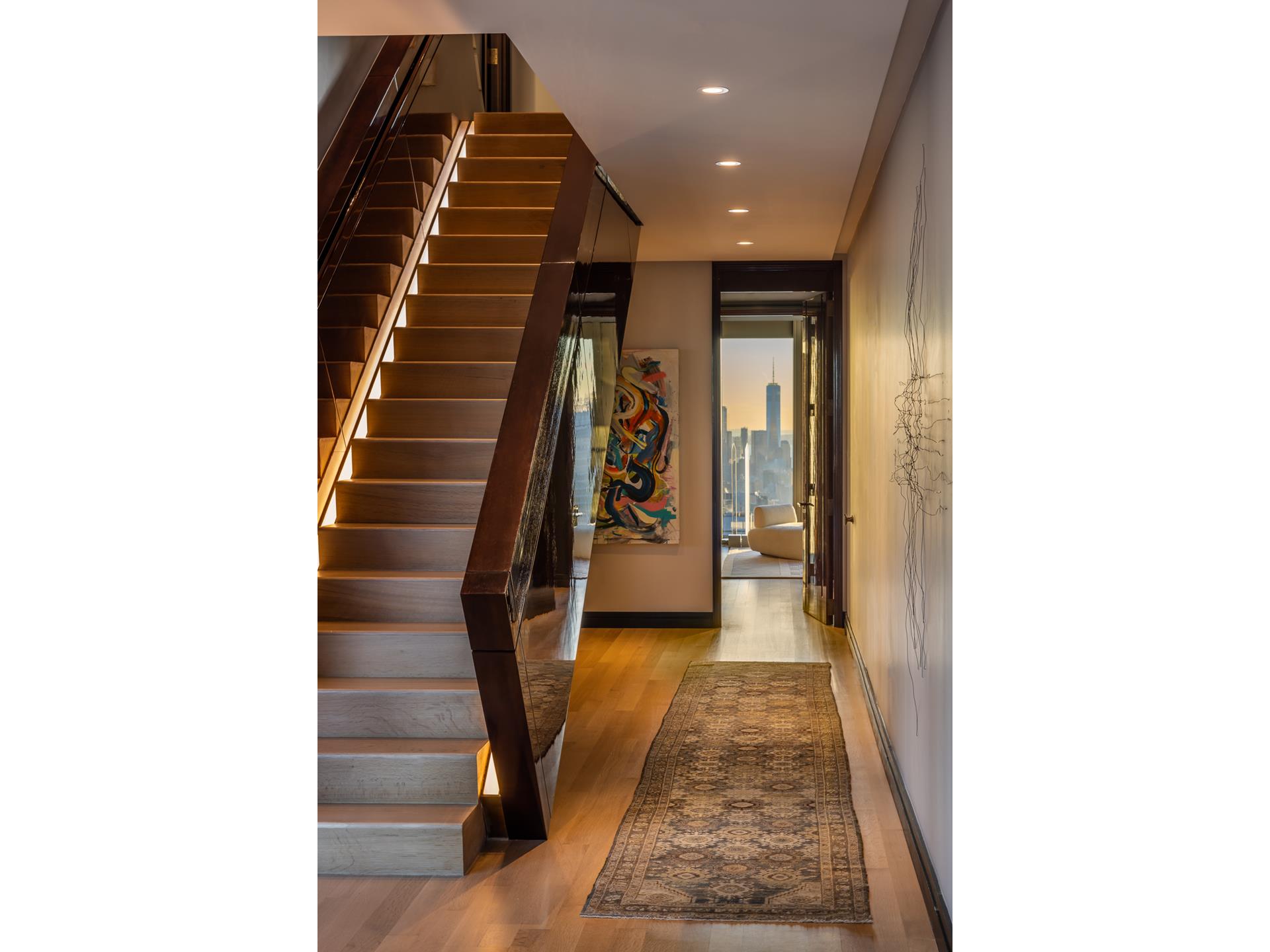 53 West 53rd Street, Unit PH78 Manhattan, NY 10019 - Photo 7 of 17 a view of a hallway with wooden floor and stairs