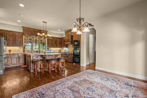 a bathroom with a granite countertop sink a mirror and a bathtub