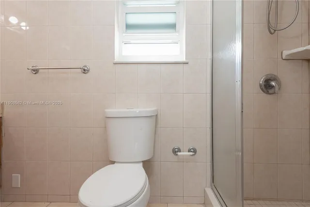 a white toilet sitting next to a bathroom sink