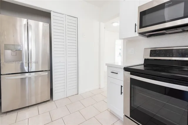 a kitchen with appliances and cabinets