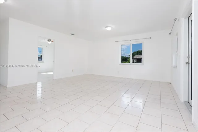 an empty room with white walls and tiles