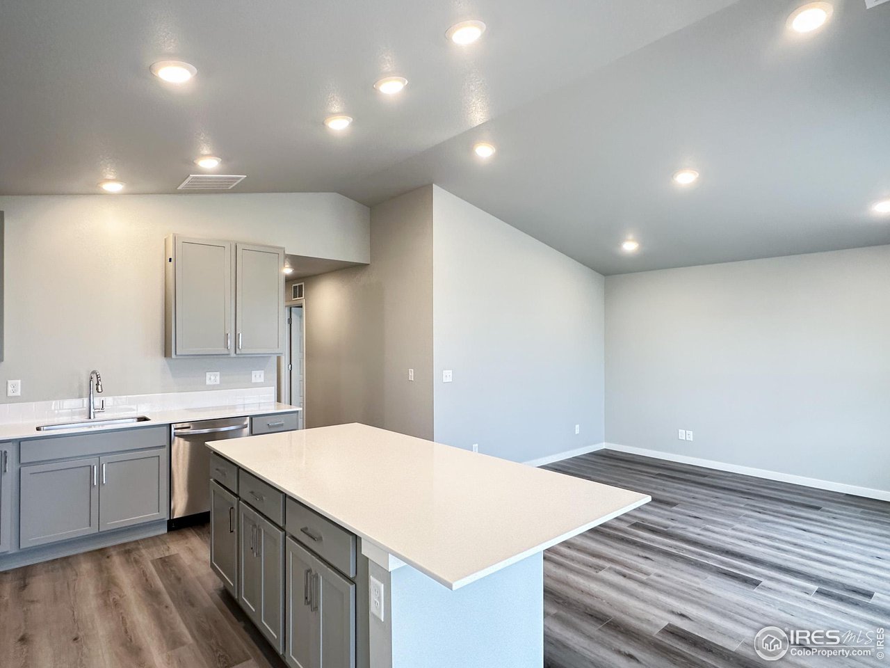 533 Bridger Avenue Fort Lupton, CO 80621 - Photo 2 of 9 a kitchen with a sink and dishwasher with white cabinets