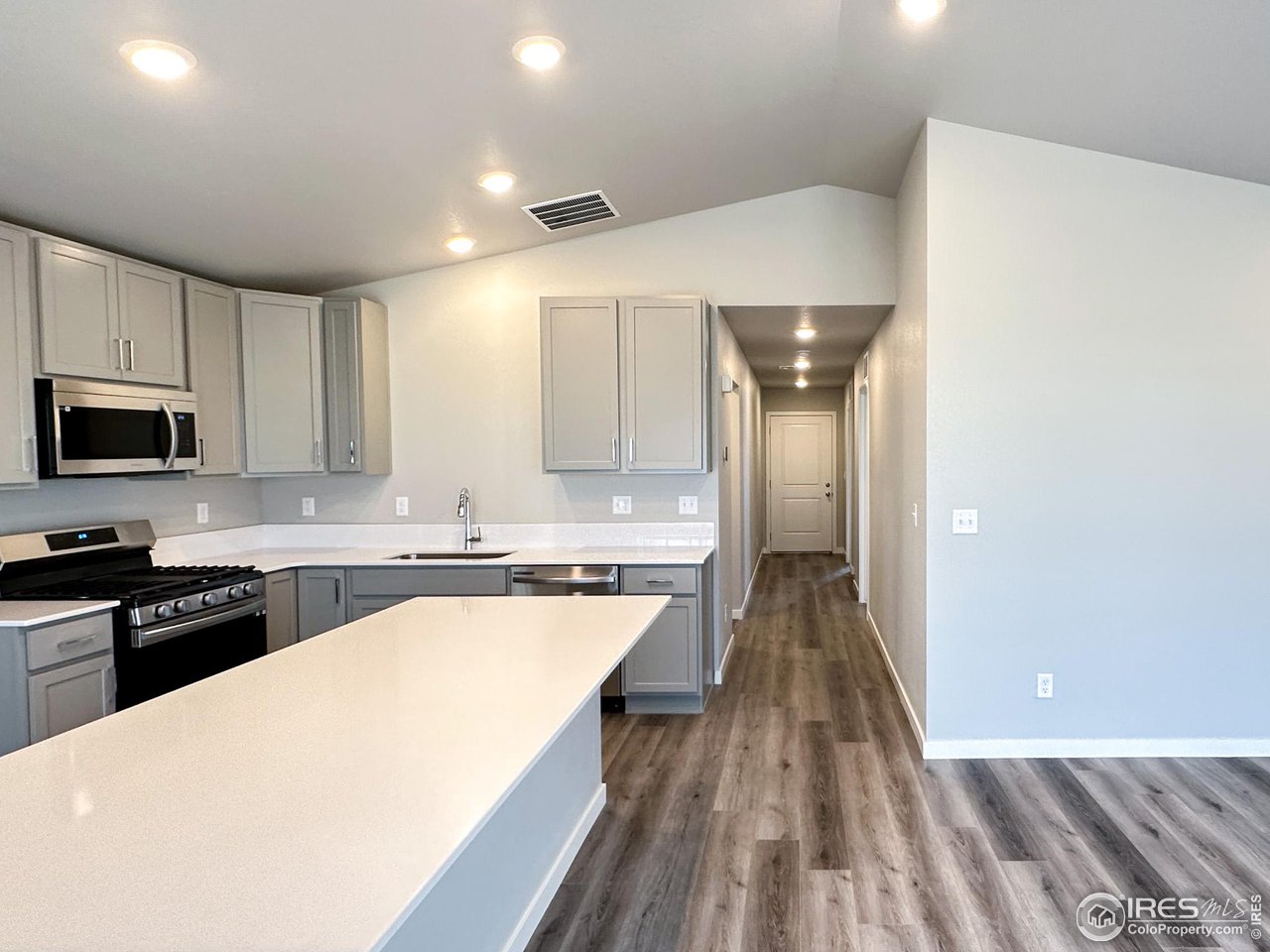 533 Bridger Avenue Fort Lupton, CO 80621 - Photo 4 of 9 a view of a kitchen with wooden floor