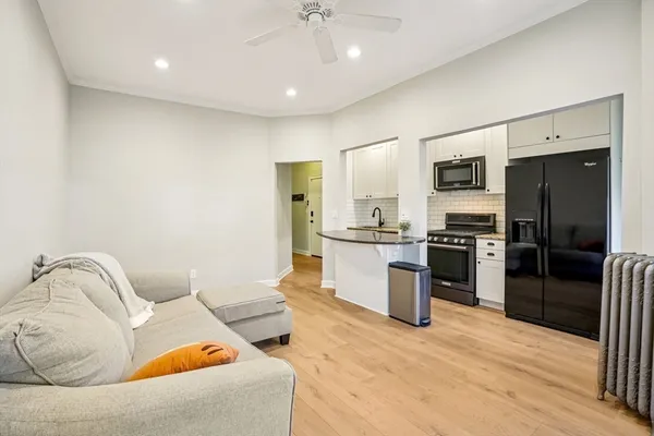 a kitchen with stainless steel appliances kitchen island granite countertop a refrigerator and a sink
