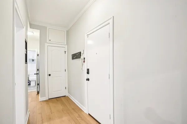 a view of a hallway with wooden floor