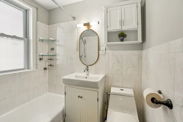 a bathroom with a sink a toilet and a mirror