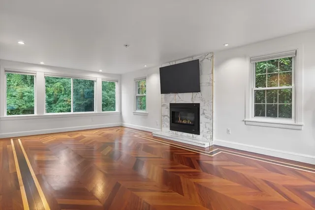 a view of empty room with fireplace and fan
