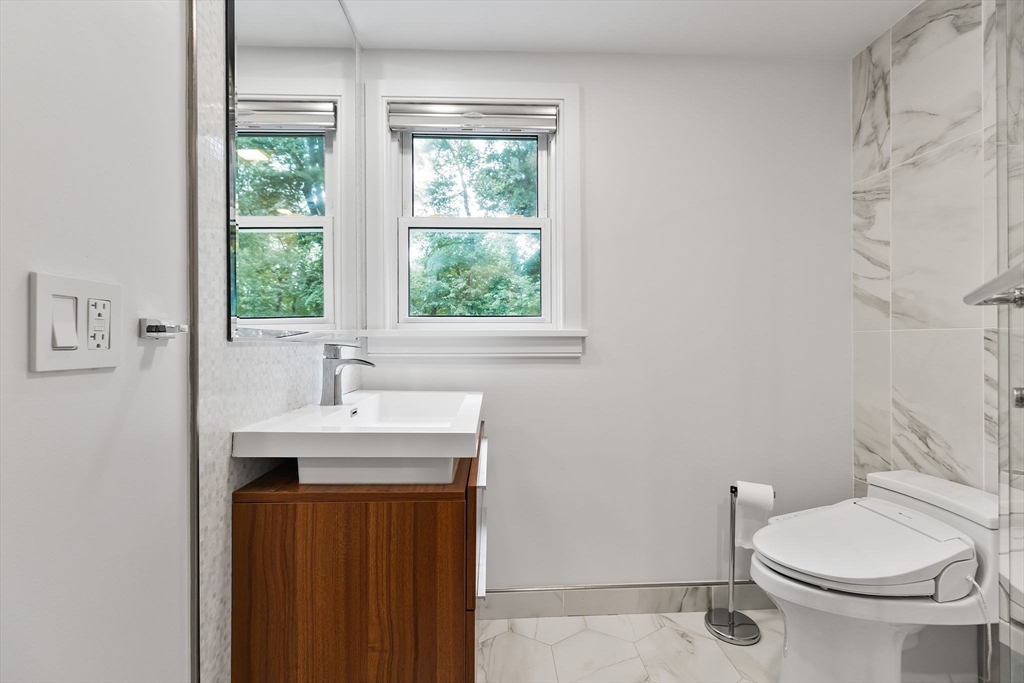 4 Hadley Road Lexington, MA 02420 - Photo 18 of 35 a bathroom with a sink a toilet and a window
