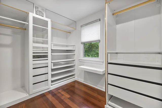a bathroom with a bathtub sink vanity and mirror