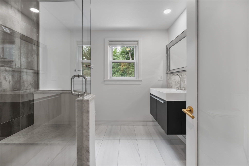 4 Hadley Road Lexington, MA 02420 - Photo 25 of 35 a bathroom with a bathtub sink vanity and mirror