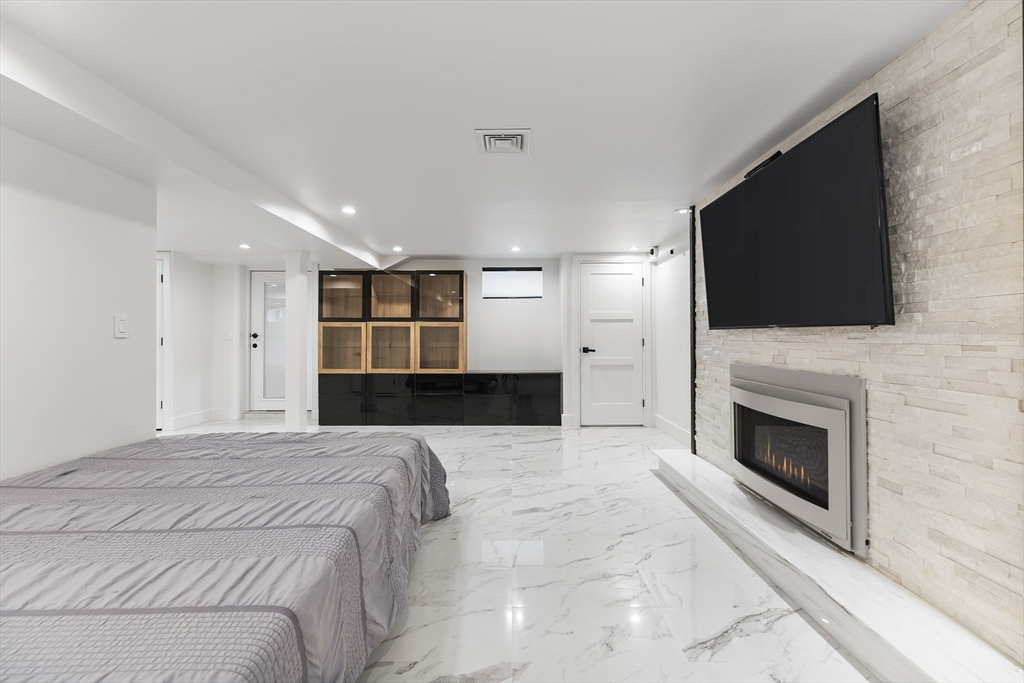 4 Hadley Road Lexington, MA 02420 - Photo 27 of 35 a large bedroom with a bed and a flat screen tv