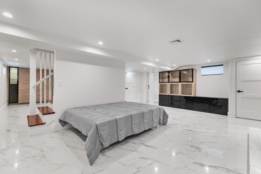 4 Hadley Road Lexington, MA 02420 - Photo 30 of 35 a spacious bedroom with a bed and walk in closet