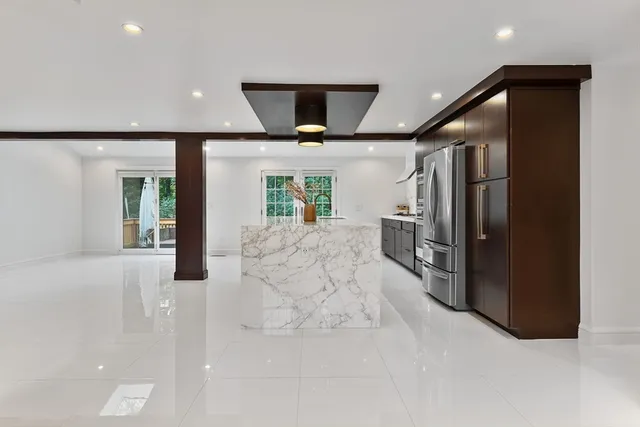 a view of a hallway with wooden floor windows and entryway