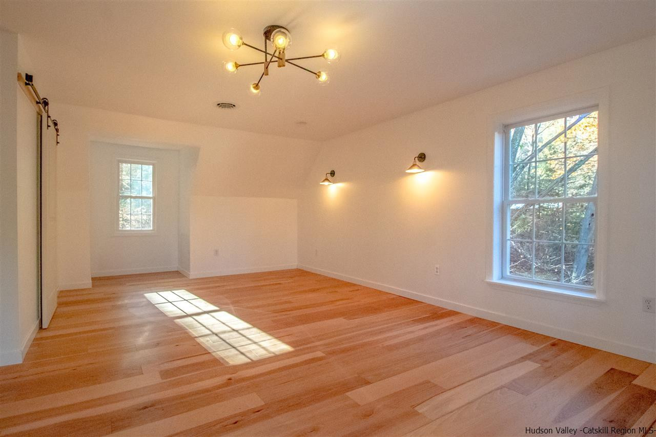 25 Laurel Hollow Road Kerhonkson, NY 12446 - Photo 19 of 30 a view of empty room with wooden floor and fan