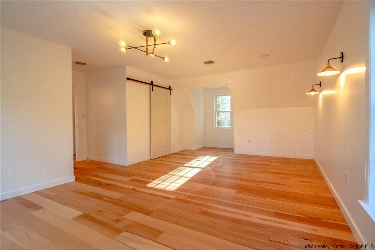 25 Laurel Hollow Road Kerhonkson, NY 12446 - Photo 21 of 30 a view of empty room with wooden floor and fan