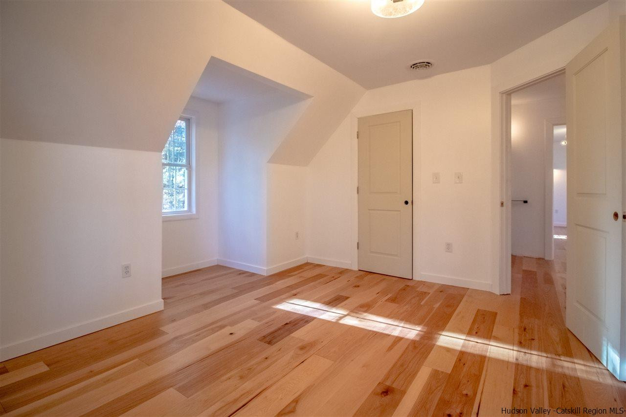 25 Laurel Hollow Road Kerhonkson, NY 12446 - Photo 24 of 30 a view of an empty room with wooden floor and a window