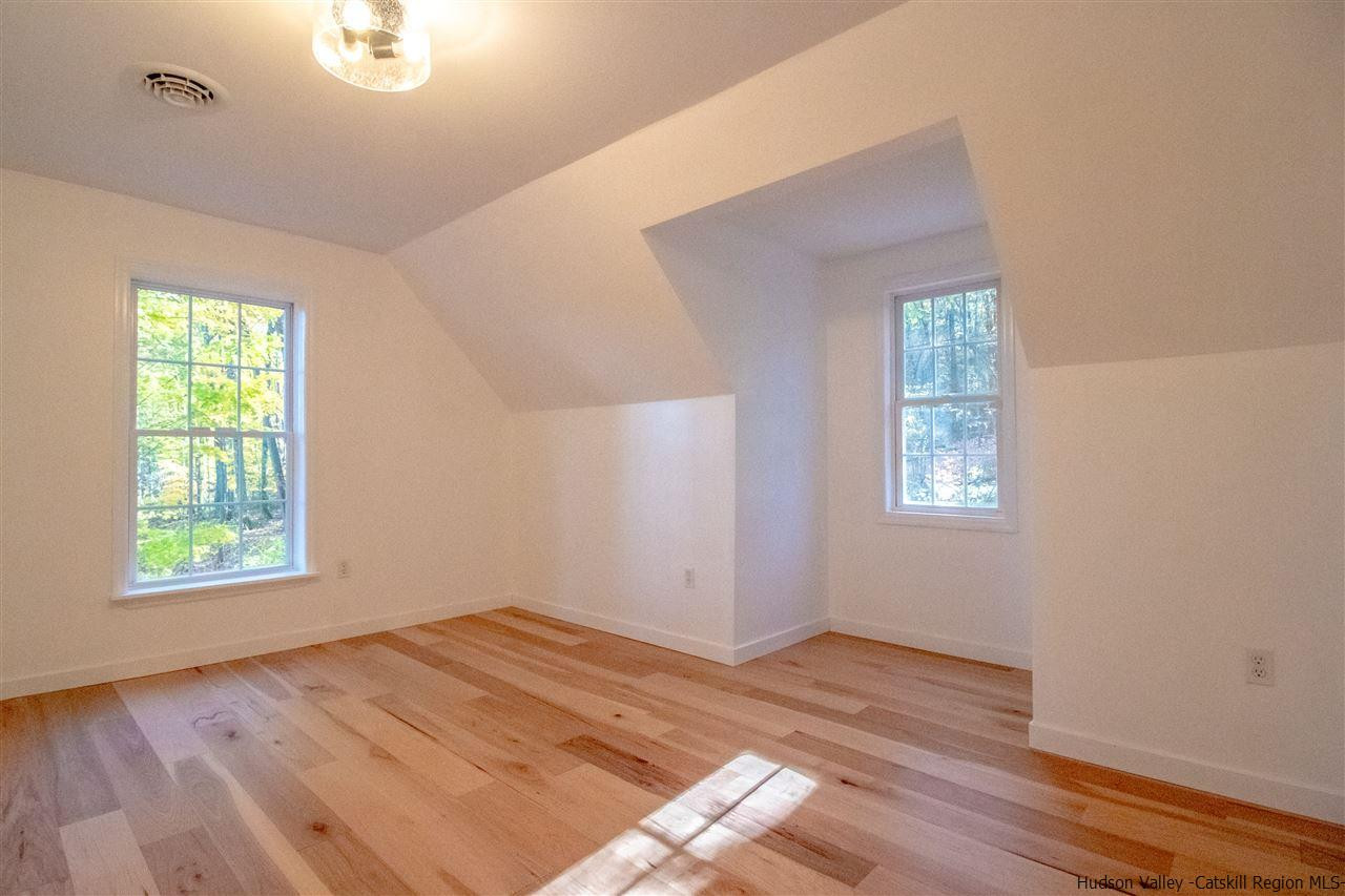 25 Laurel Hollow Road Kerhonkson, NY 12446 - Photo 25 of 30 an empty room with wooden floor and windows