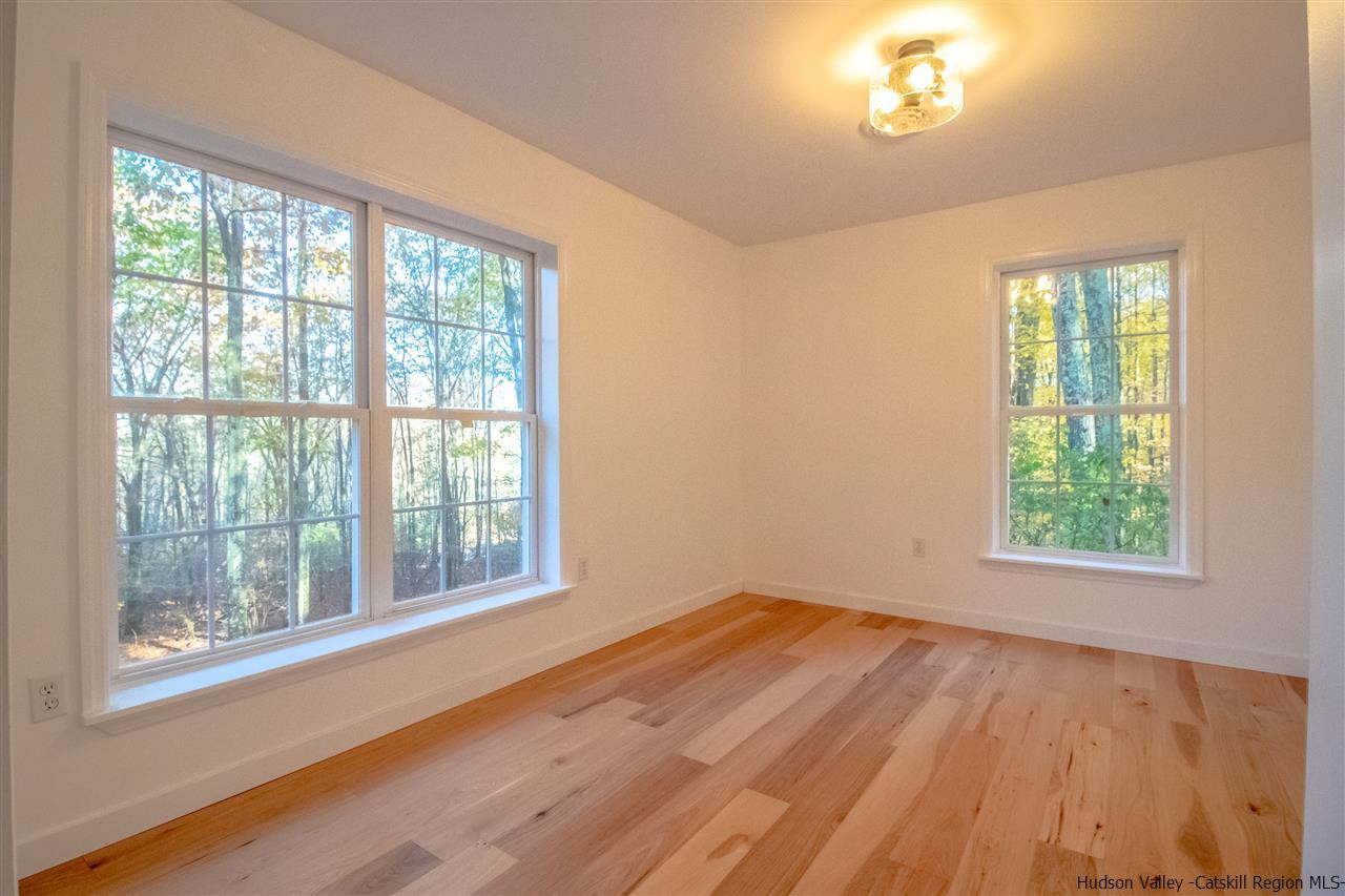 25 Laurel Hollow Road Kerhonkson, NY 12446 - Photo 3 of 30 a view of an empty room with wooden floor and a window