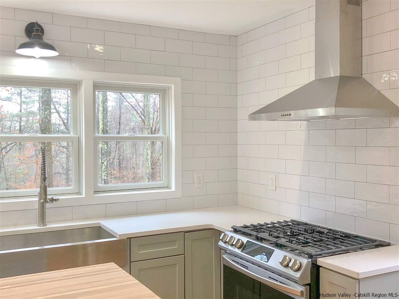 25 Laurel Hollow Road Kerhonkson, NY 12446 - Photo 5 of 30 a kitchen with a stove a window cabinets and a counter top space