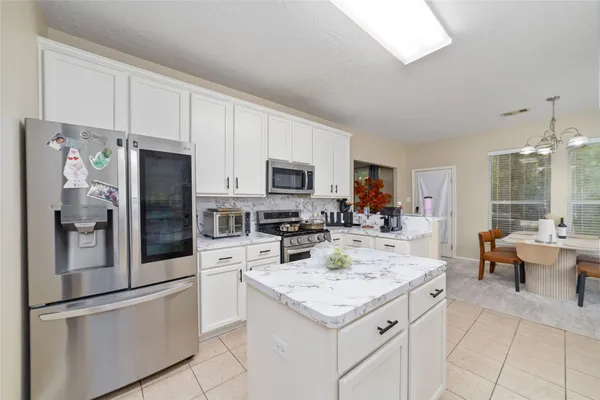 a kitchen with a refrigerator and microwave