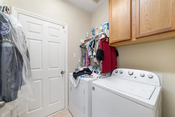 a view of storage and utility room with washer and dryer
