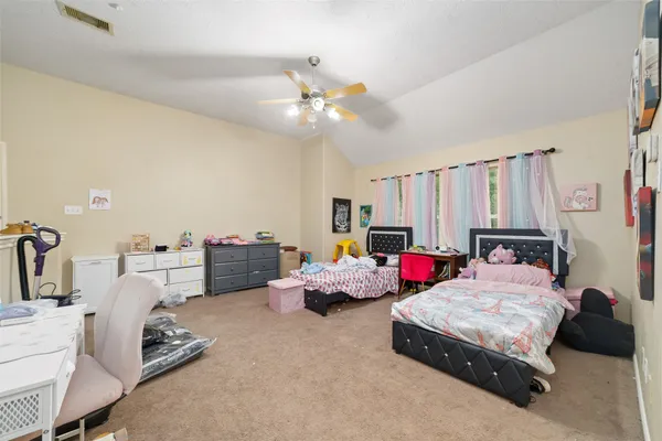 a bedroom with furniture and a chandelier