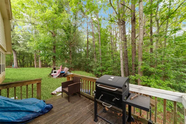 a view of a roof deck with table and chairs and wooden fence