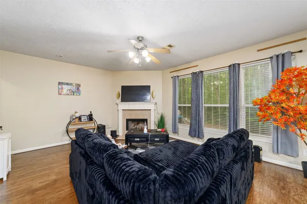 a living room with furniture and a floor to ceiling window