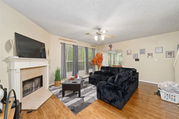 a living room with furniture fireplace and flat screen tv