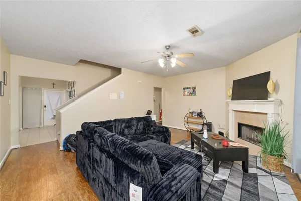 a living room with furniture a fireplace and a flat screen tv