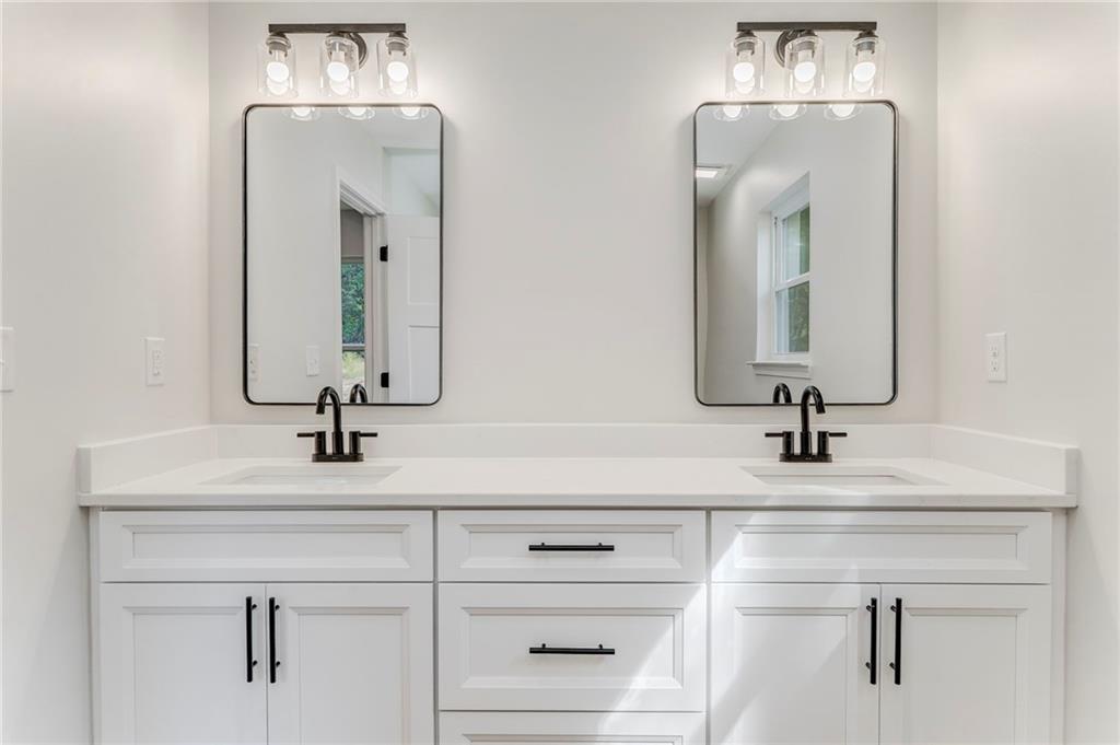 22 Earls Way Chatsworth, GA 30705 - Photo 16 of 64 a bathroom with double vanity sinks and a mirror