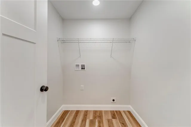 a view of a kitchen with a sink dishwasher and wooden floor