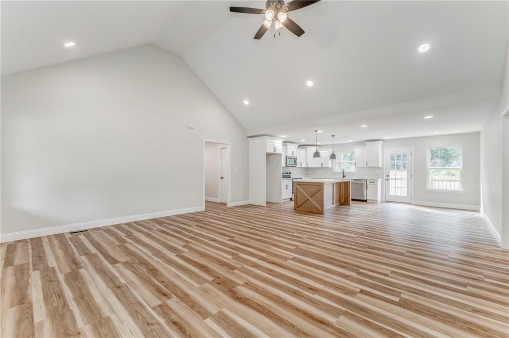 22 Earls Way Chatsworth, GA 30705 - Photo 23 of 64 a view of a room with kitchen island stainless steel appliances wooden floor and windows
