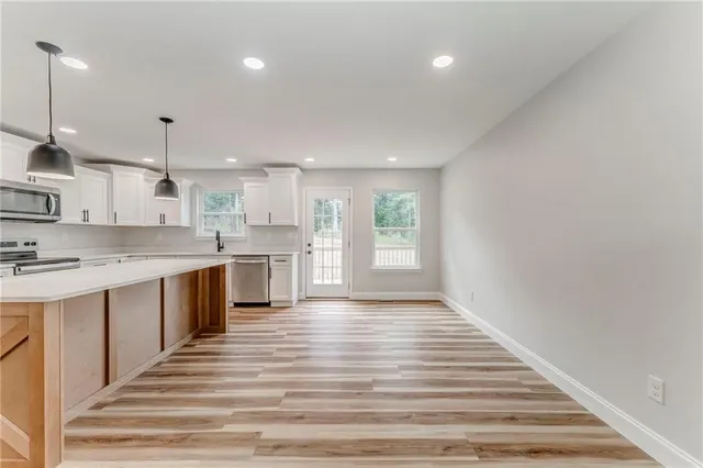 a kitchen with stainless steel appliances granite countertop a sink and stove top oven