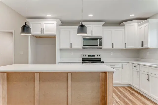 a kitchen that has a sink a window and cabinets
