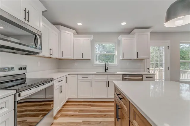 a view of a room with wooden floor and white wall