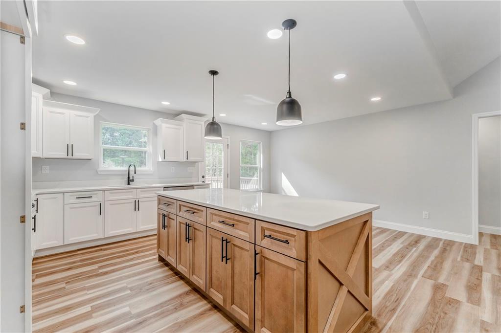 22 Earls Way Chatsworth, GA 30705 - Photo 42 of 64 a kitchen with stainless steel appliances granite countertop a sink a stove and a wooden floors